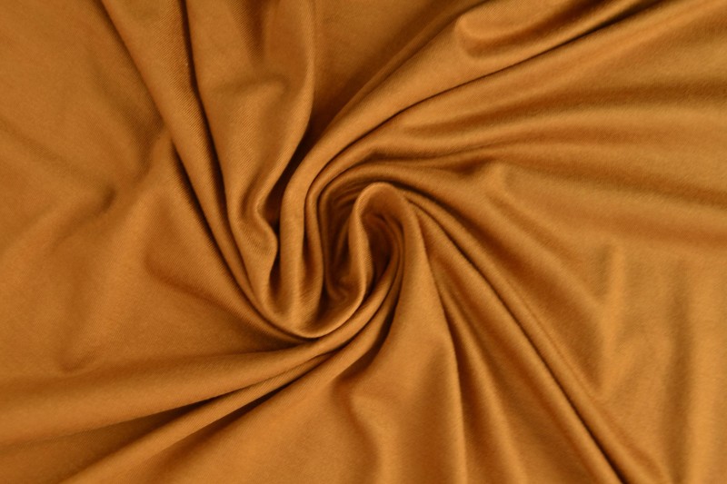 Viscose tricot donker okergeel